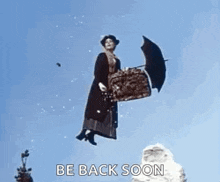 a woman is flying through the air with a suitcase and umbrella .