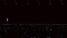 a man stands on a stage in front of a crowd and says no