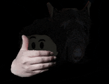 a hand is giving a thumbs up in front of a cartoon character