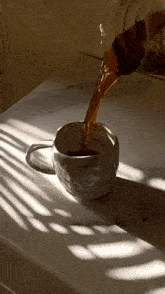 a cup of coffee is being poured into it