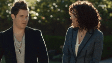 a man and a woman are standing next to each other with the word mox on the bottom right