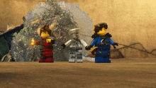 a group of lego figures are standing in front of a waterfall