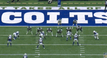 a football game is being played in front of a colts banner