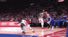 a basketball game is being played on a kia sponsored court