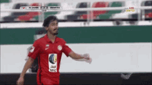 a soccer player wearing a red shirt that says epic