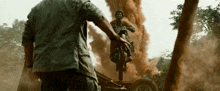 a man is riding a motorcycle on a trailer with smoke coming out of it