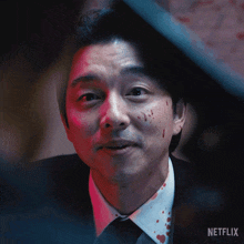 a close up of a man 's face with a netflix logo on the bottom