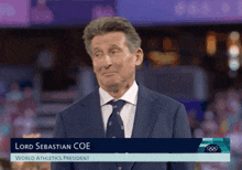 a man in a suit and tie with the name lord sebastian coe