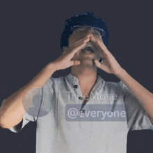 a man covering his face with his hands and a sticker that says truemose