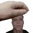 a hand is holding a man 's head in a pixel art .