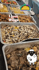 several trays of food on a table with the words " i love wings " on the top