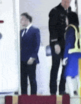 a blurry picture of a man in a suit and tie