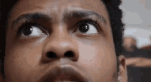 a close up of a man 's face looking up at the camera .