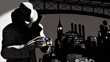 a man in a hat is holding a rubik 's cube in his hands .
