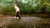 a person is walking in the rain with a skateboard
