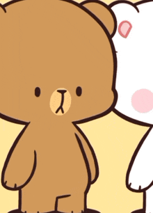 a brown teddy bear is standing next to a white teddy bear with a heart on its ear