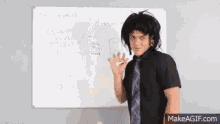 a man in a wig is standing in front of a white board