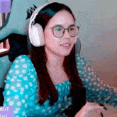 a woman wearing glasses and headphones sitting in a chair