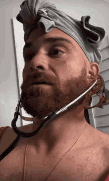 a man with a stethoscope around his neck is wearing a headband