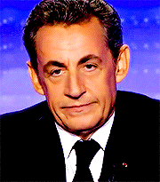 a man in a suit and tie with a serious look on his face