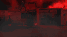 a person standing on the roof of a building with lightning strikes