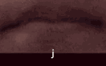 the letter j is on a dark background