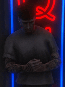 a man with a tattoo on his arm is standing in front of a neon sign