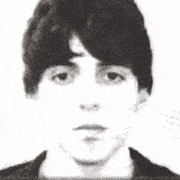 a black and white photo of a young man