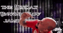 a bald man in a red shirt is standing in front of a sign that says " the sunday unwint low jamz "