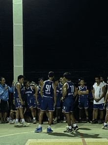 a group of basketball players wearing blue jerseys with the number 91 on them