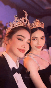 two women wearing crowns are posing for a picture with the caption babim.coz