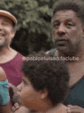 a man with a beard is standing next to a young boy with pabloeluisao.faclube written on the bottom right