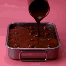 a pan filled with chocolate and cherries with the words mr.cakes written on the bottom
