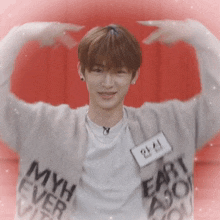 a young man wearing a sweater that says myth ever alive