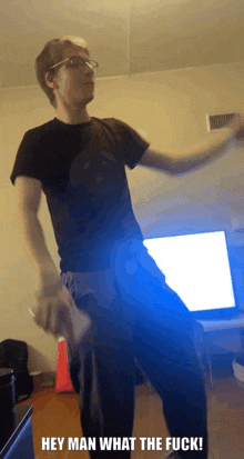 a man in a black shirt is dancing with the words hey man what the fuck in the corner