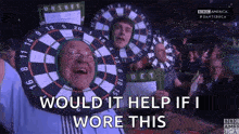 a man is wearing a dart board on his head and says would it help if i wore this