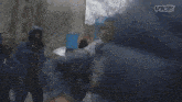 a group of people are hugging each other in front of a playground .