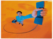 a man in a blue shirt is holding a large blue phone