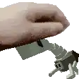 a person 's hand is holding a toy spider with long legs .