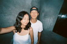 a man and a woman are posing for a picture together