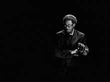 a man in a suit and tie with sunglasses on