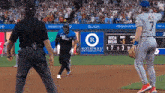a baseball game is being played in front of a rothman orthopaedics ad