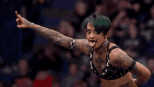 a woman with green hair is making a funny face and sticking out her tongue .