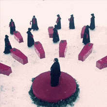 a woman stands in the middle of a circle of red coffins in the snow