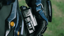 a person wearing a black glove is holding a black object