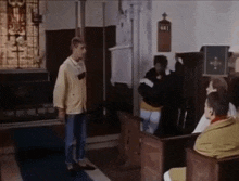a group of people in a church with the number 481 on the wall behind them