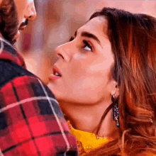 a man and a woman are looking at each other .