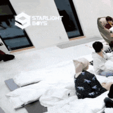 a group of starlight boys are laying on their stomachs on the floor