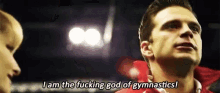 a man in a red shirt is talking to a child and saying `` i am the fucking god of gymnastics '' .