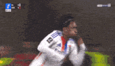 a soccer player celebrates a goal during a game